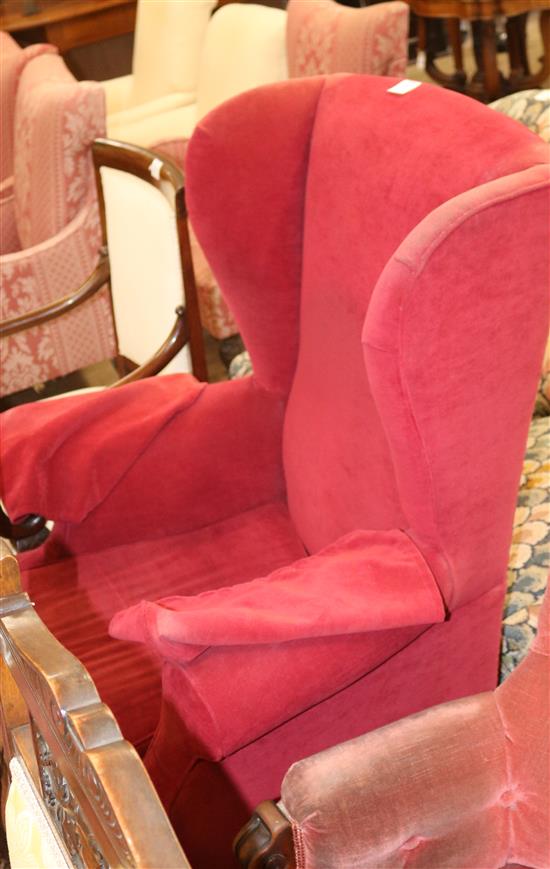 A Georgian style upholstered wing armchair